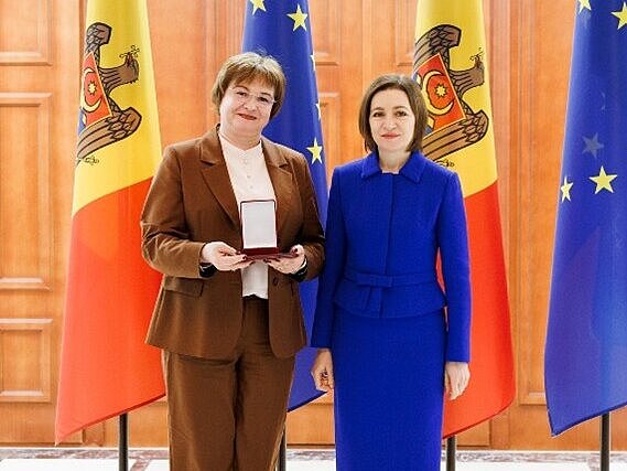 Two women pose for a photograph.