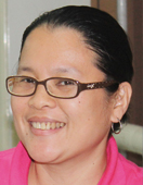 A portrait of a woman smiling into the camera.